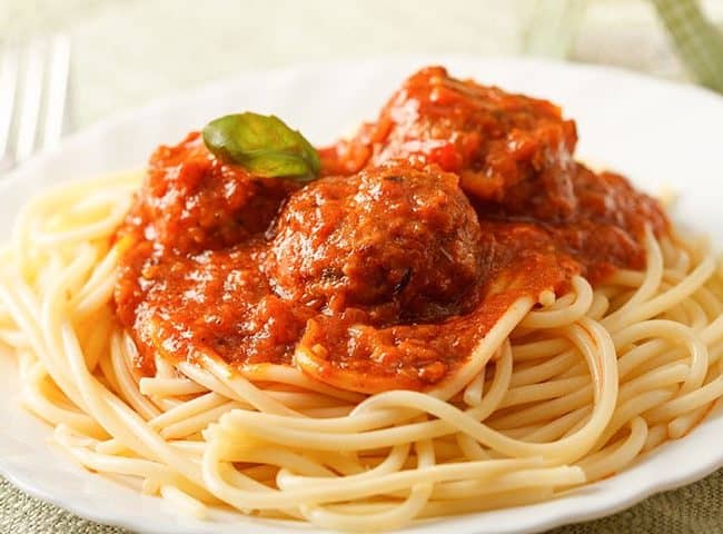 Italian Sausage Meatballs & Spaghetti & Pasta on a plate garnished with herbs