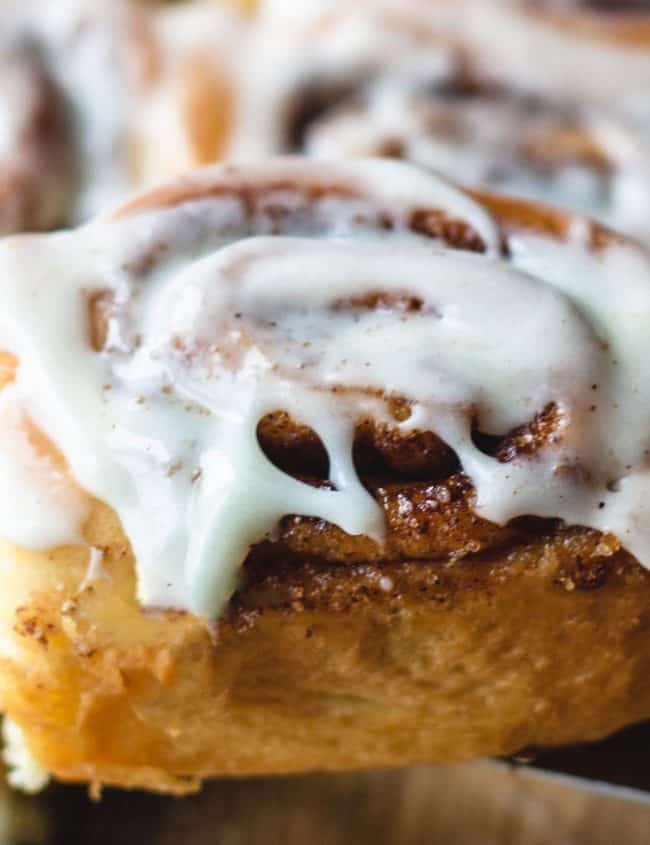 a glazed cinnamon roll being served