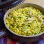 Easy One Pot Chicken and Saffron Rice in a serving dish, sprinkled with chopped parsley