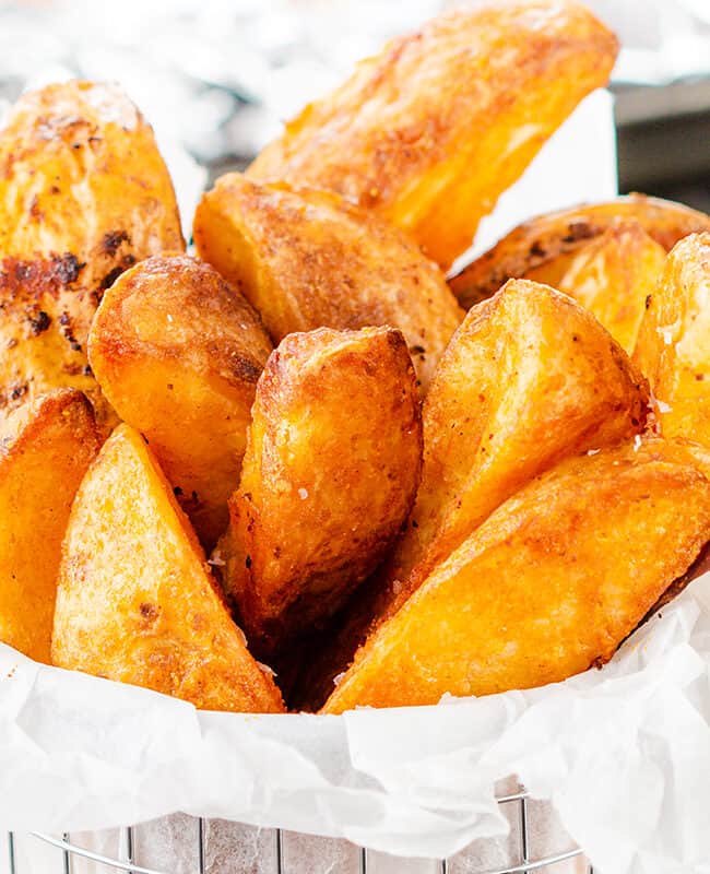 a metal basket filled with crispy, golden Potato Wedges