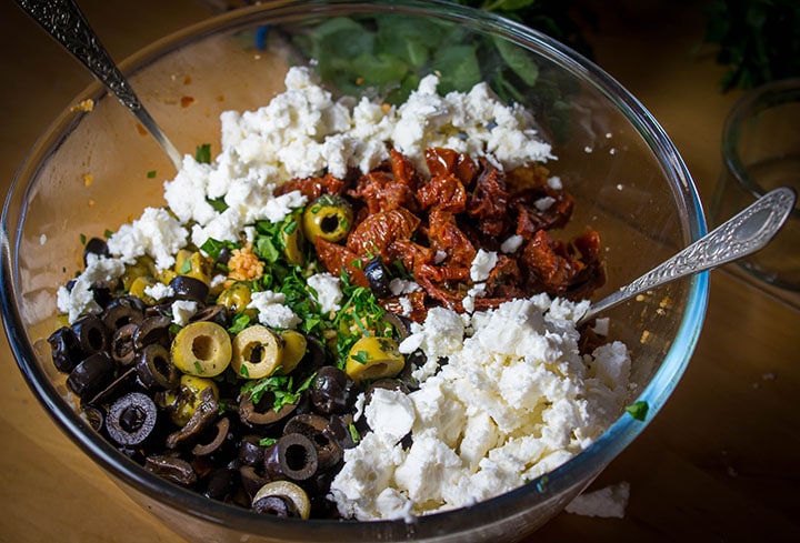 The salad fixings on top of the couscous