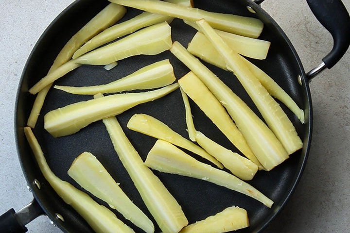 The cooked parsnips added to a pan