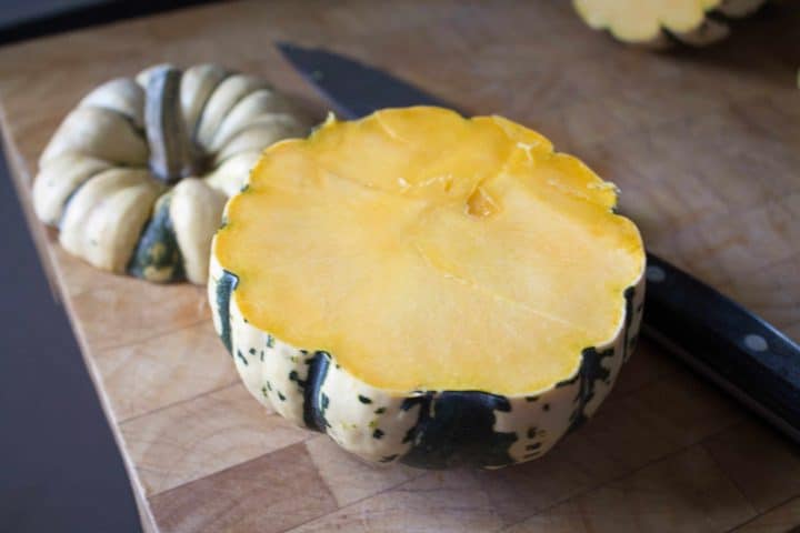 winter squash with the top removed, ready to remove the seeds