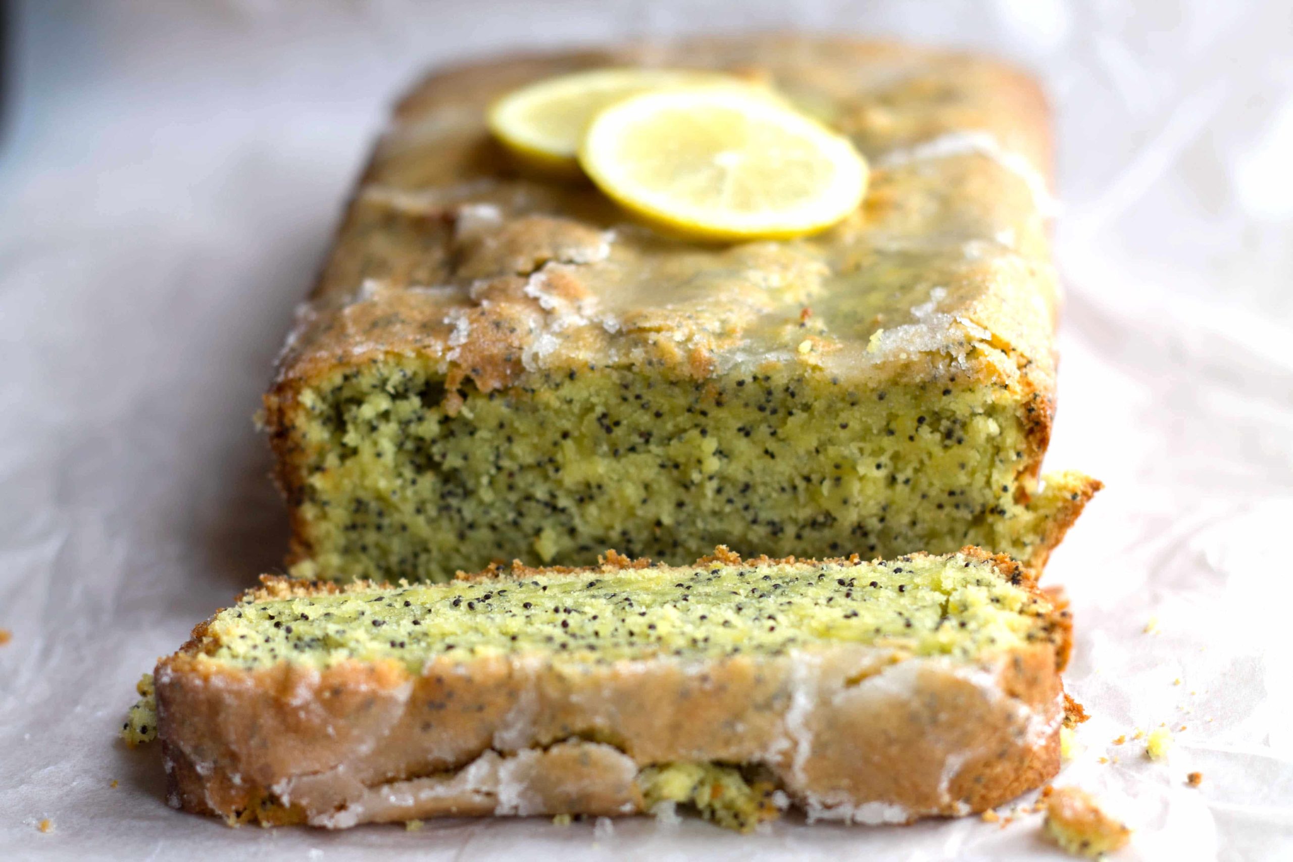 Lemon Poppy Seed Drizzle Cake - Erren's Kitchen - Lemon Drizzle Cake is a classic English recipe. Poppy seeds add a bit of a twist to this classic citrus cake with a crunchy sugar topping and moist texture.