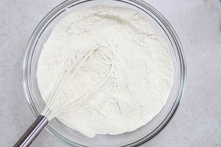 The dry ingredients for the cake in a glass bowl