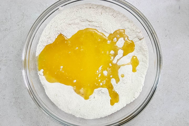 Melted butter added to the bowl with the flour mixture