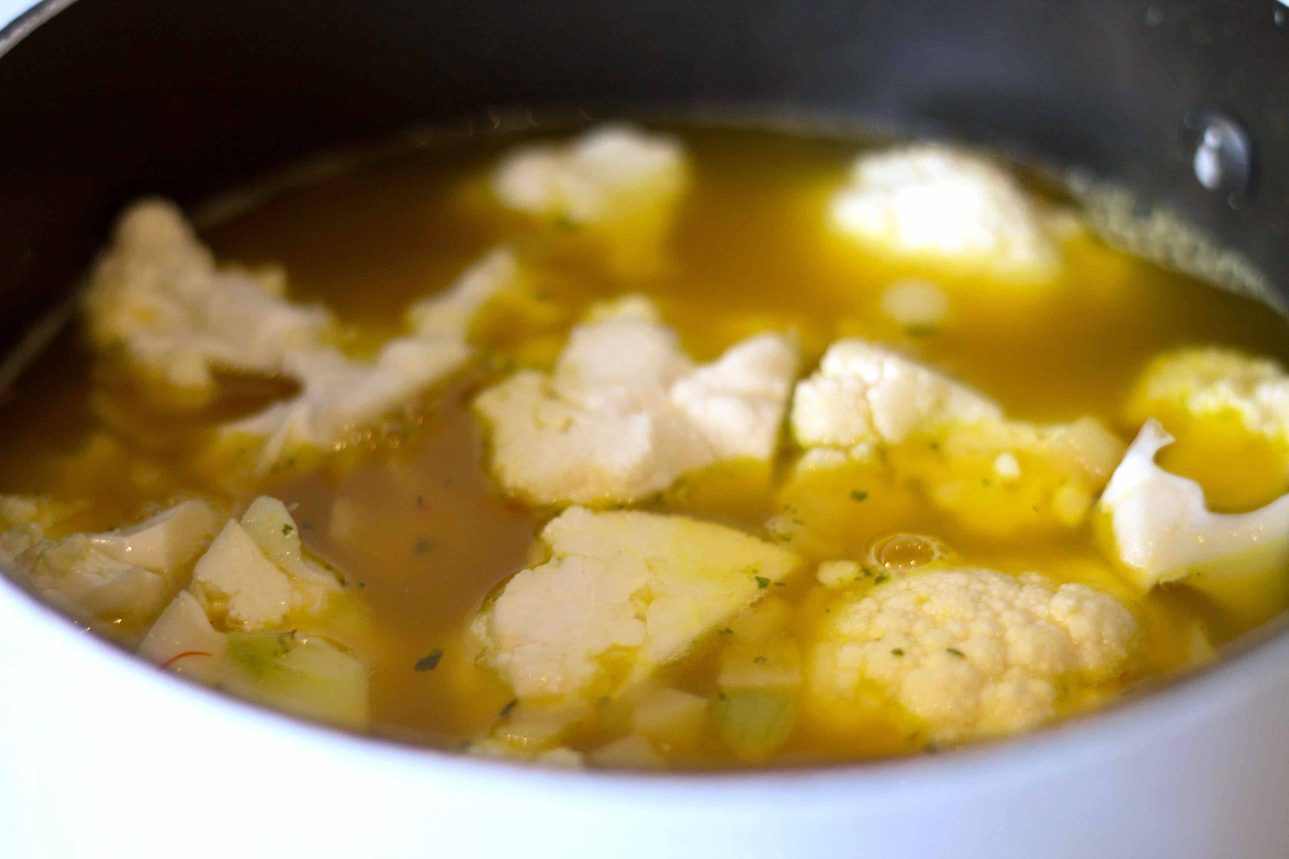 Cauliflower in a pan covered with stock