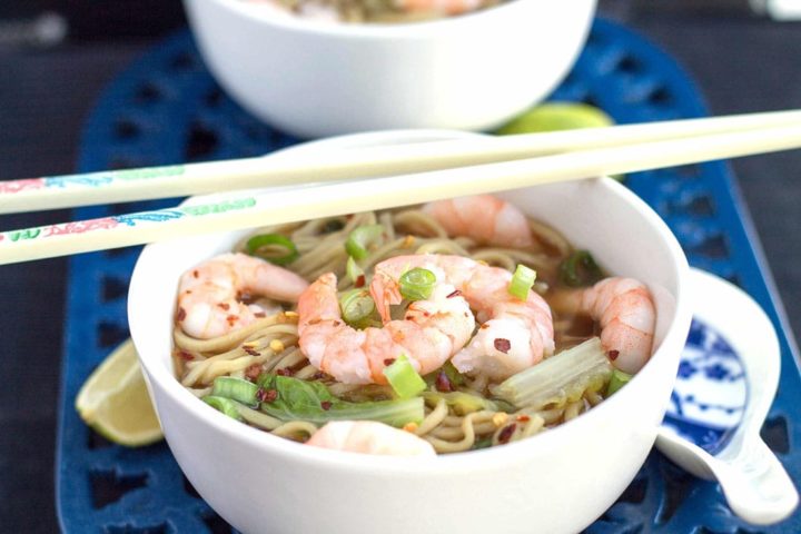 A bowl of the Quick Chinese Shrimp Noodle Soup with shrimp on the top and chop sticks over the bowl