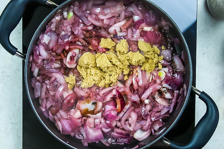 The vinegar and brown sugar added to the onions in the pan 