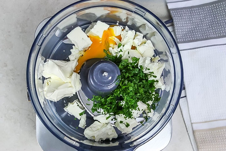 The feta, egg, cream cheese and parsley in a food processsor 