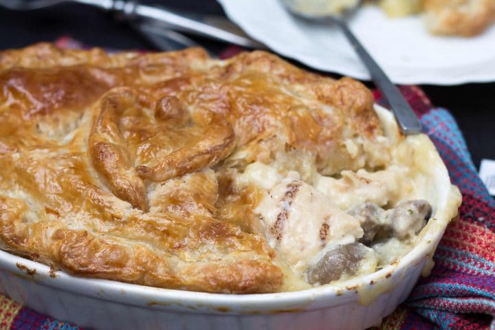 Cheesy Chicken & Mushroom Pie with a piece removed showing the filling