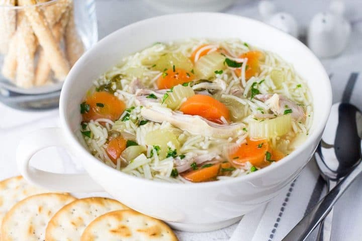 a bowl of chicken noodle soup ready to eat