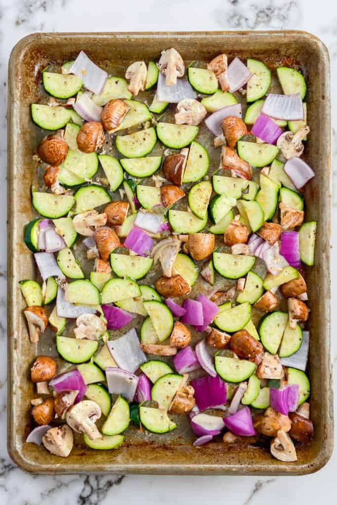 The vegetables spread in a single later over a sheet pan.