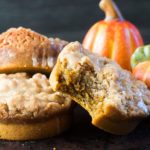 Mini Pumpkin Coffee cakes stacked with a bite out of one of them.