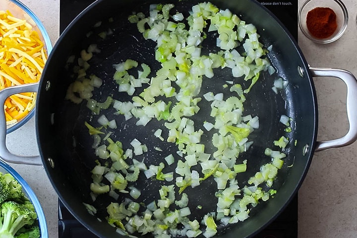 Celery, and onions sauteing in a pan