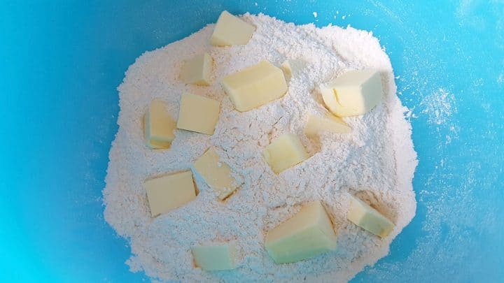 flour with butter cubed in a bowl