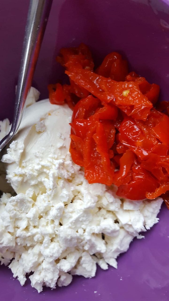 chopped peppers with feta cheese and a spoon