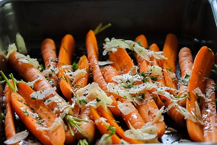 salt, pepper and chopped parsley added to the carrots in the pan