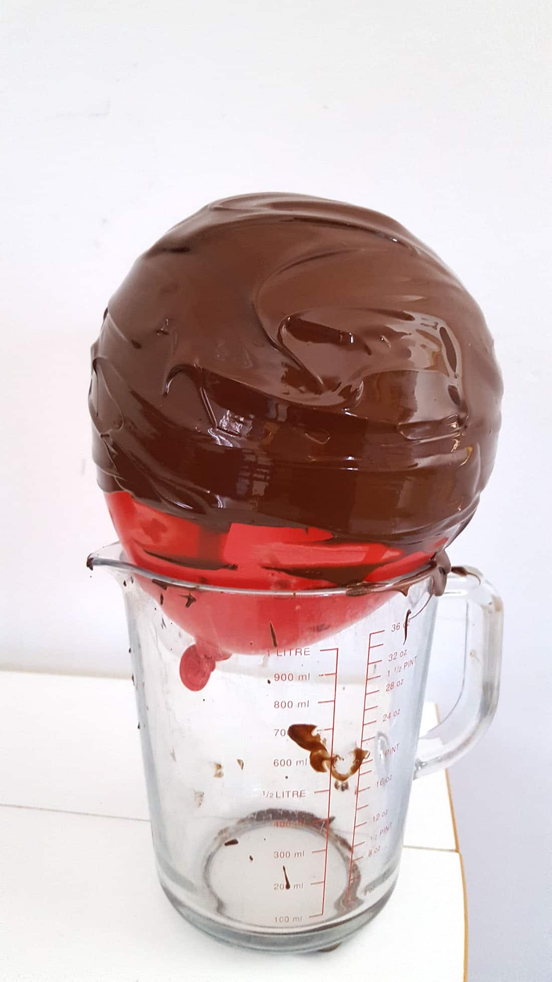 Chocolate Christmas Smash Cake - prep three - chocolate covered balloon resting on a jug