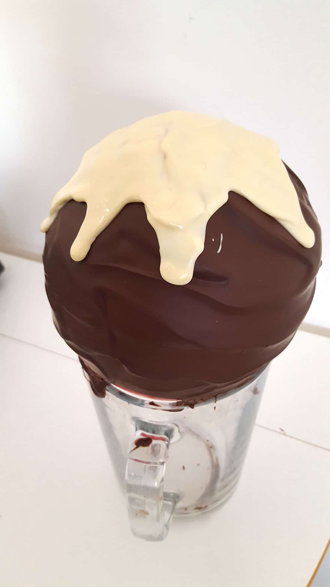 Chocolate Christmas Smash Cake - white chocolate on top of milk chocolate covered balloon