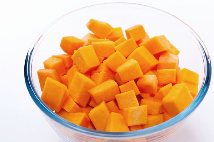 Squash cut into cubes in a clear glass bowl