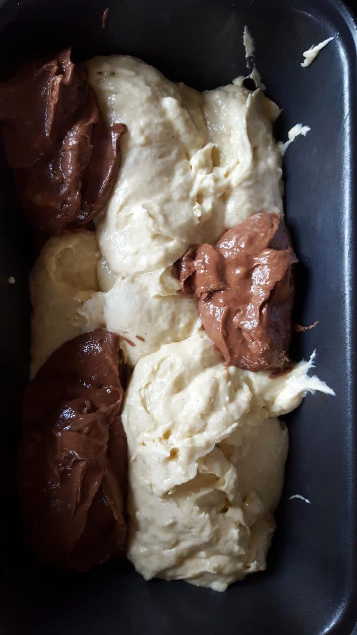 The batter in the spooned into the pan alternating between chocolate and vanilla 