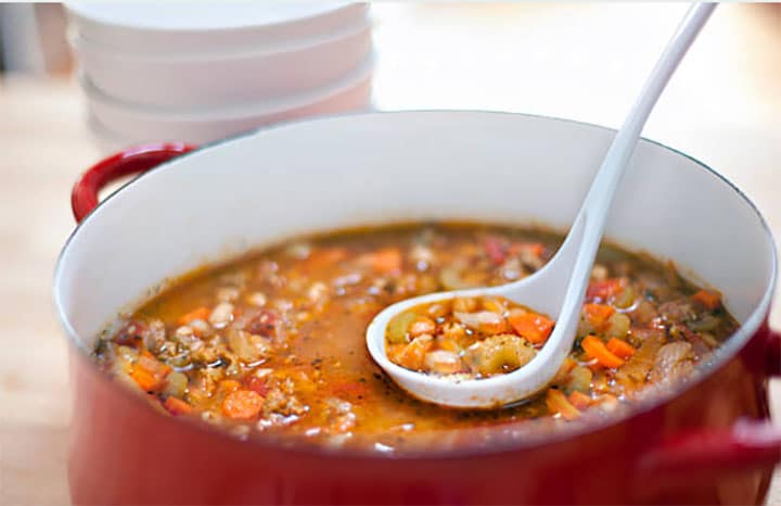 Pasta Fagioli being served from a large pot