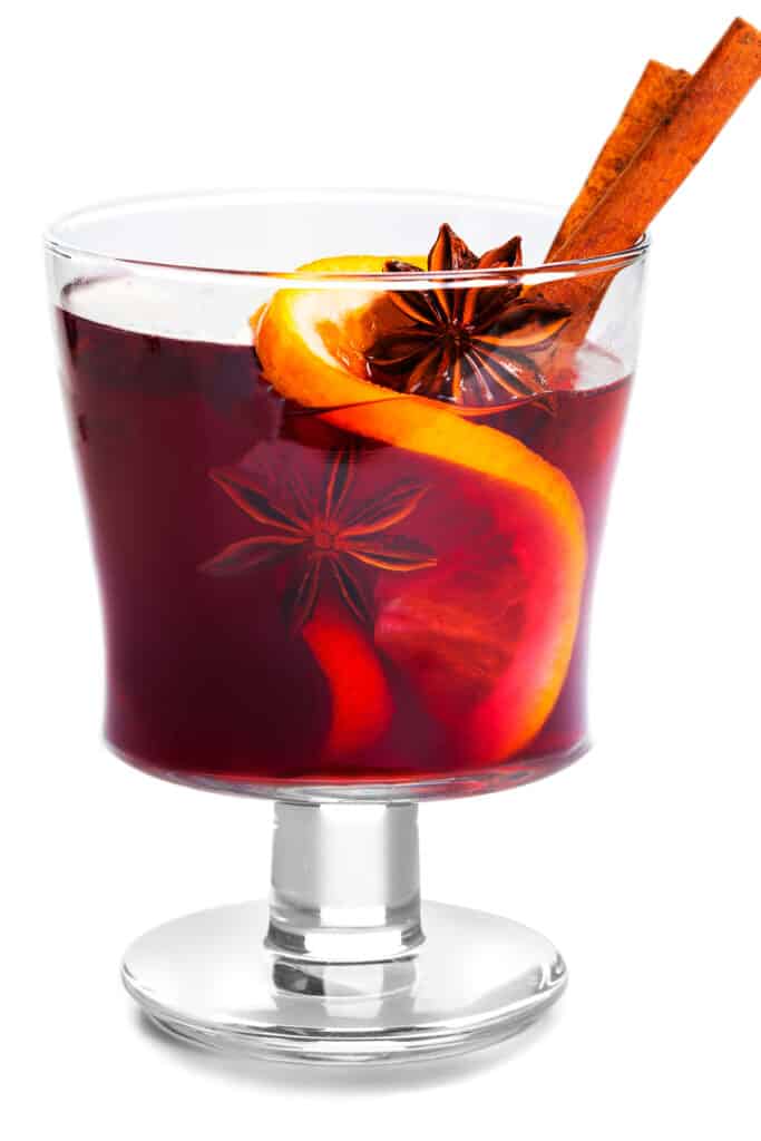 Cranberry Holiday Cocktail with Vodka in a glass with an orange slice, star anise and cinnamon stick