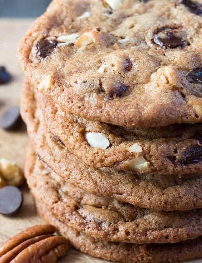 A close up of a pile of nutty chocolate chip cookies