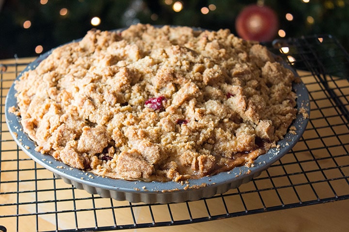 apple cranberry crumb pie cooling on a wire rack