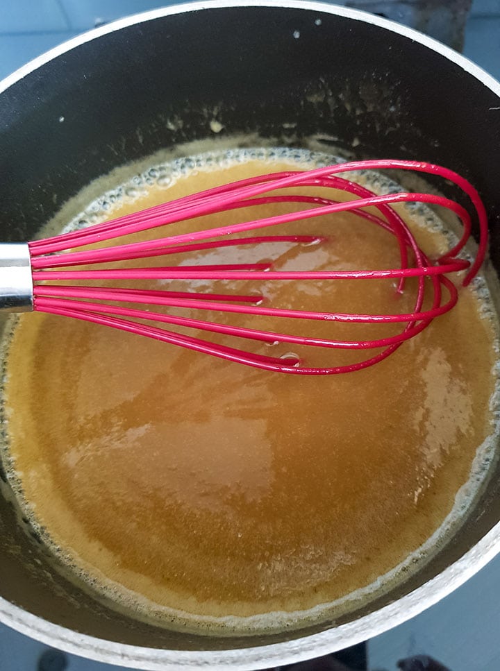 The caramel glaze cooking in the pan