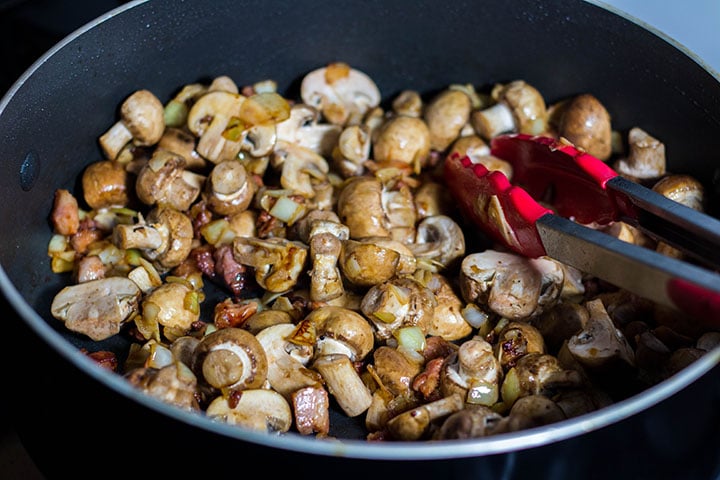 The mushrooms added to the pan with the bacon, onions and garlic