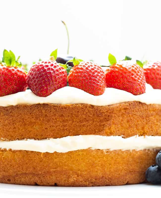 a layer cake topped with fruit