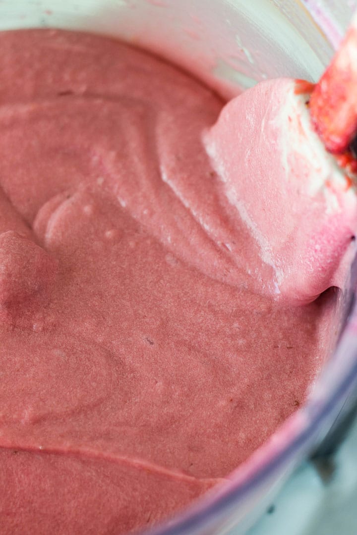 The pale pink, strawberry cake batter mixed together