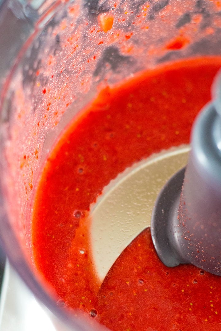 pureed strawberries in a food processor bowl.