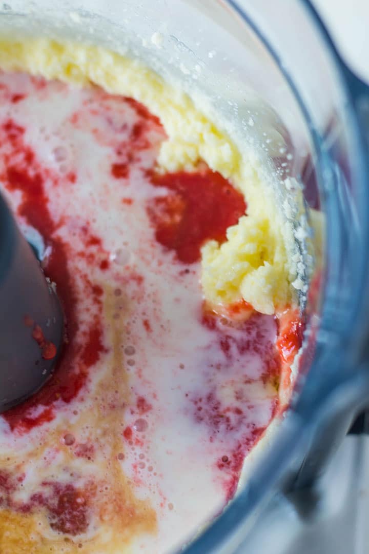 the milk and strawberry liquid added to the butter and sugar