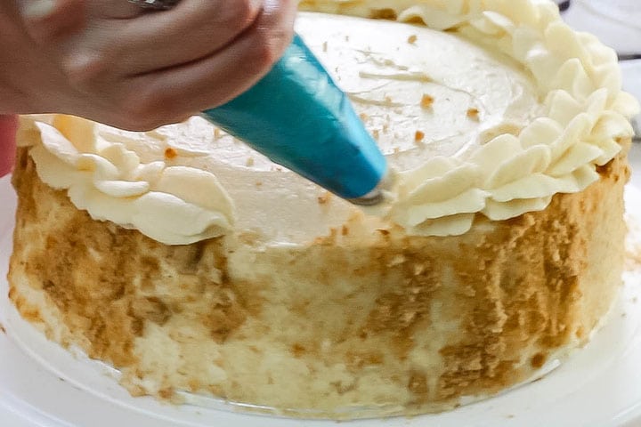 The edge being piped onto the cake