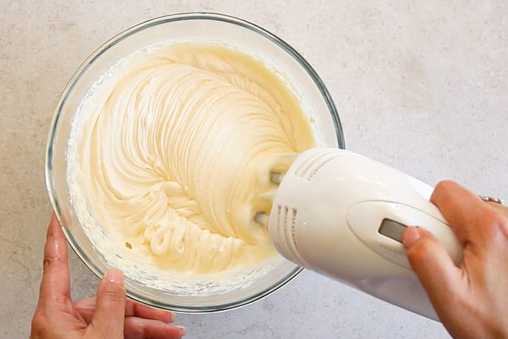 The whipped cream frosting whipping in a bowl