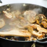 Mushrooms cooking in a pan.