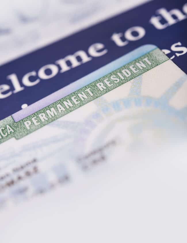 United States Green Card and Welcome Brochures Vertical Closeup Photo.