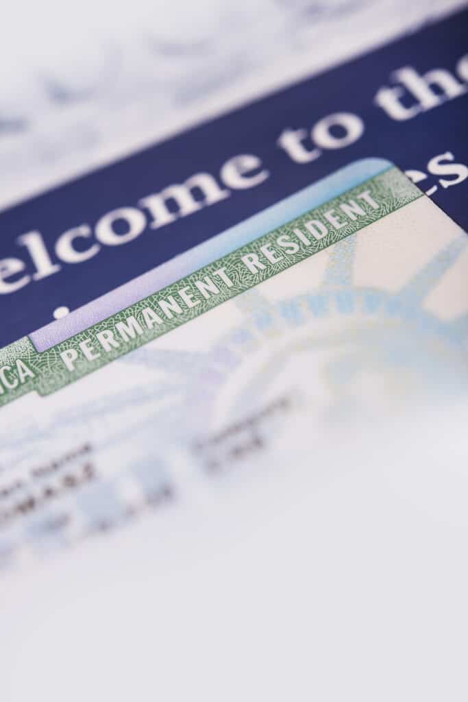 United States Green Card and Welcome Brochures Vertical Closeup Photo.