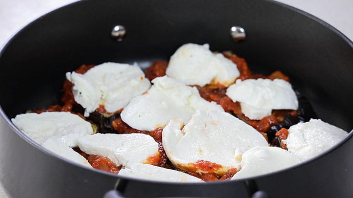 mozzarella slices topping the eggplant and sauce