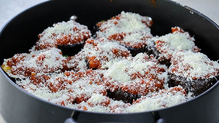 more sauce and the grated Parmesan cheese added to the top of the layers