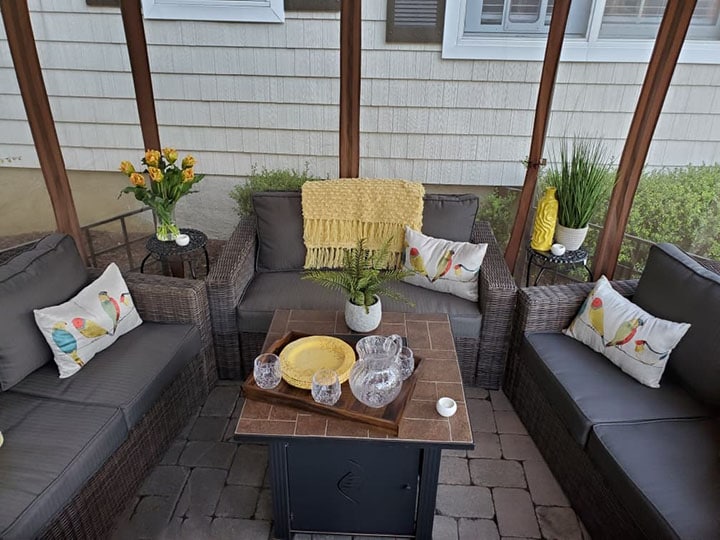 a gazebo with patio furniture and fire pit