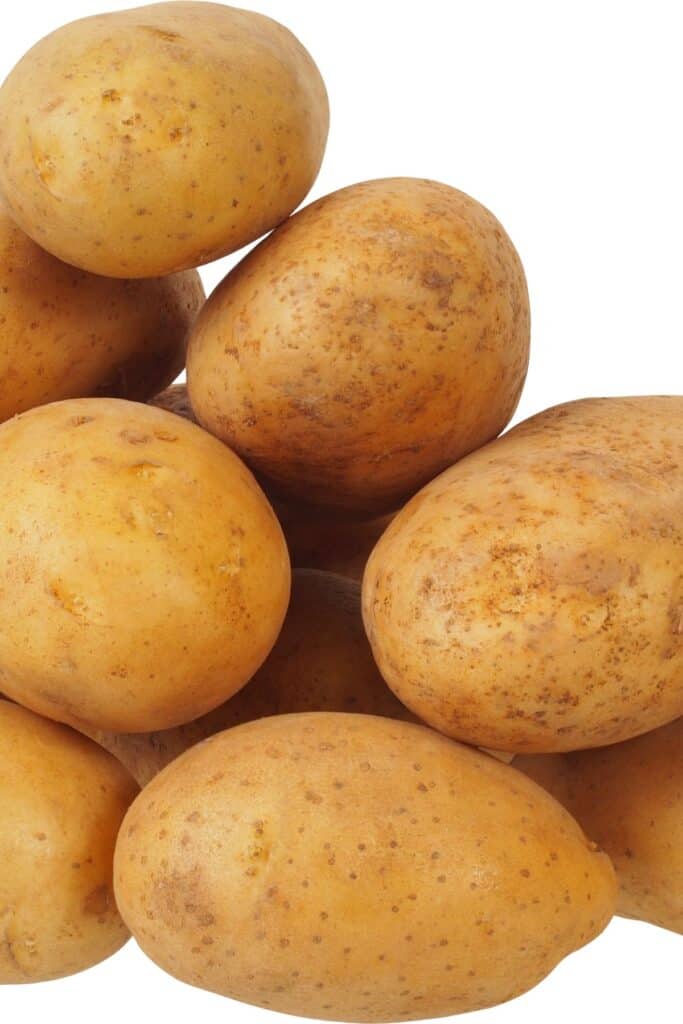 a pile of potatoes with a white background