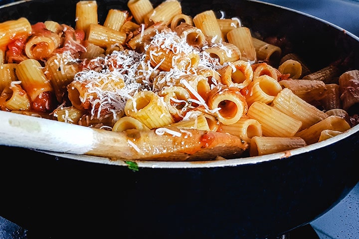 the grated cheese added to the pan with the pasta and sauce