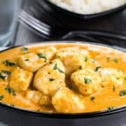 Chicken Korma in a serving dish sprinkled with fresh corriander