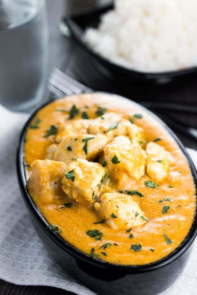 Chicken Korma in a serving dish sprinkled with fresh corriander