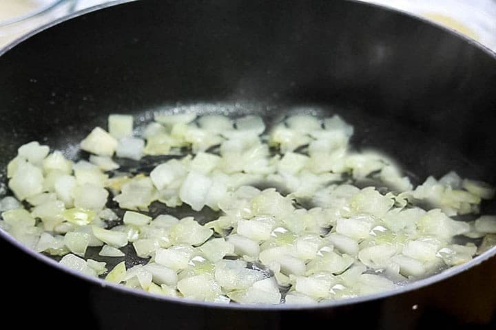 The chopped onion cooking in the pan