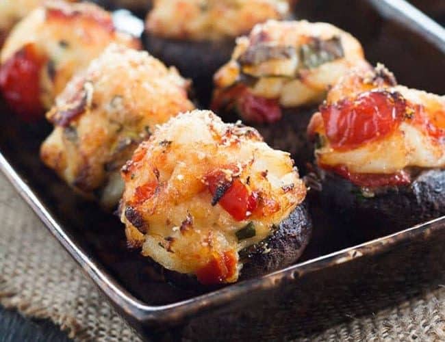 crab stuffed mushrooms lined up on a serving dish